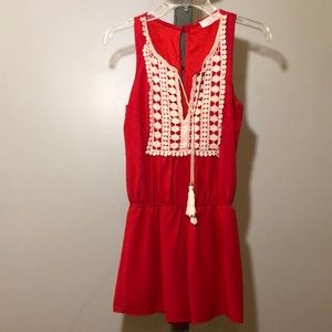 Sleeveless red romper.